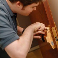 Man installing a door lock