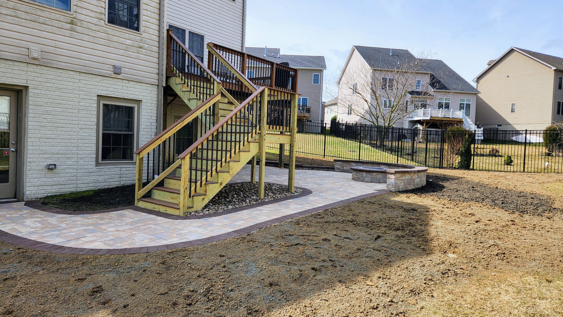 a house with a deck and stairs in the backyard .