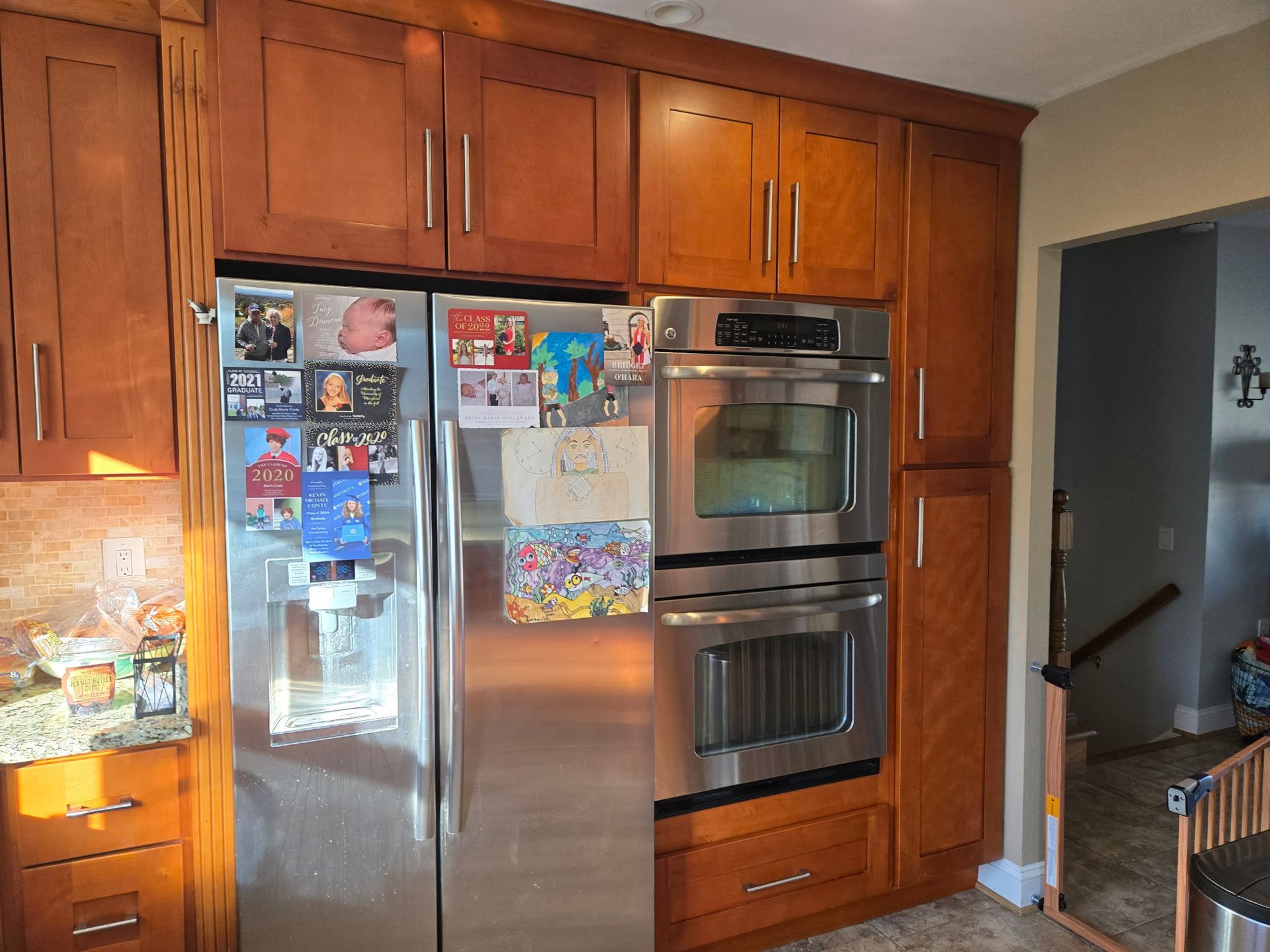 A kitchen with stainless steel appliances and wooden cabinets