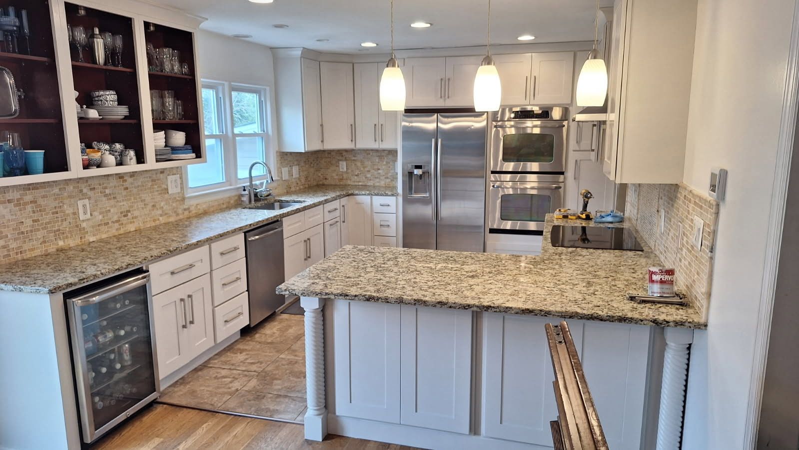 A kitchen with granite counter tops and stainless steel appliances.