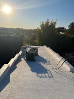 The sun is shining brightly on the roof of a building.