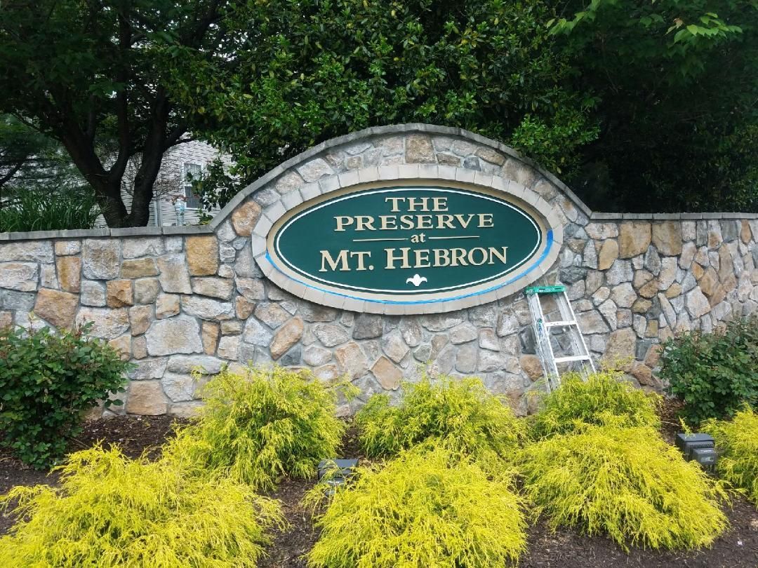 a stone wall with a sign that says the preserve of mt hebron