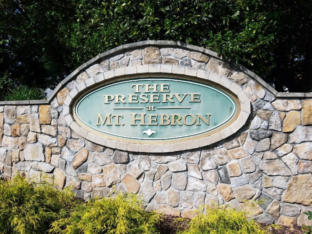 a stone wall with a sign that says the preserve at mt hebron