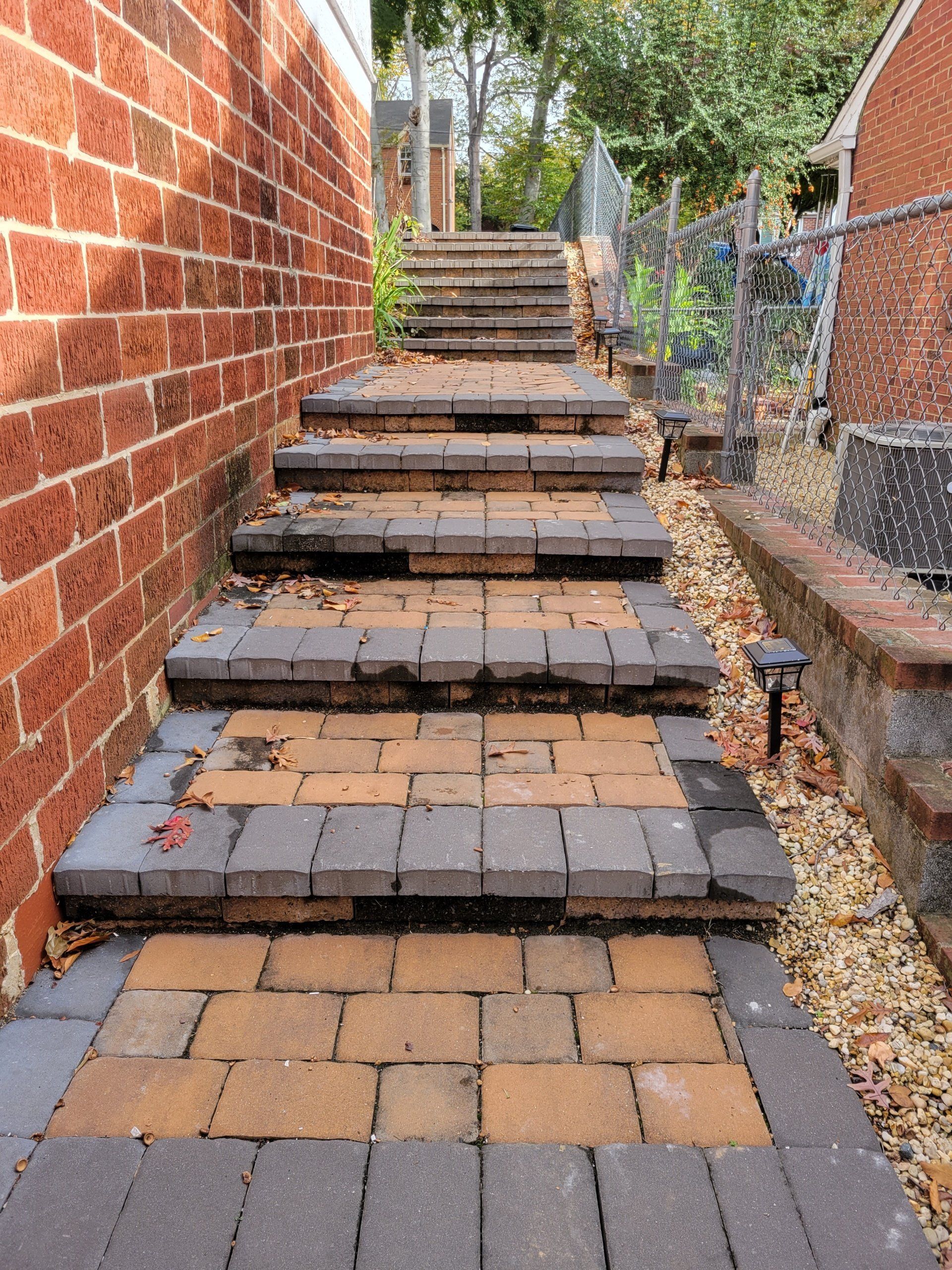 a set of brick stairs leading up to a brick wall