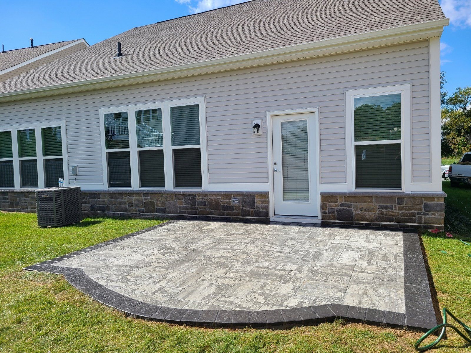 a large white house with a patio in front of it