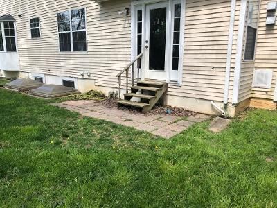 a house with a patio and stairs in front of it