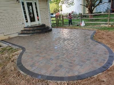 a patio is being built in front of a house