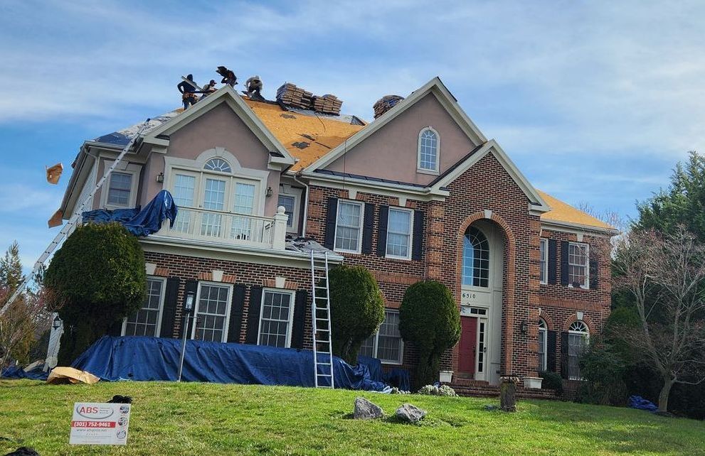 a large brick house is being remodeled with a new roof