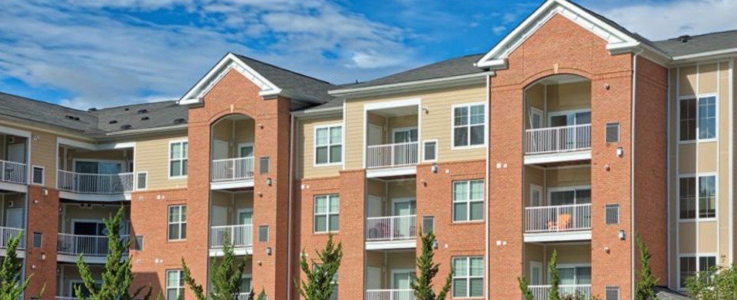 a large apartment building with a lot of windows and balconies