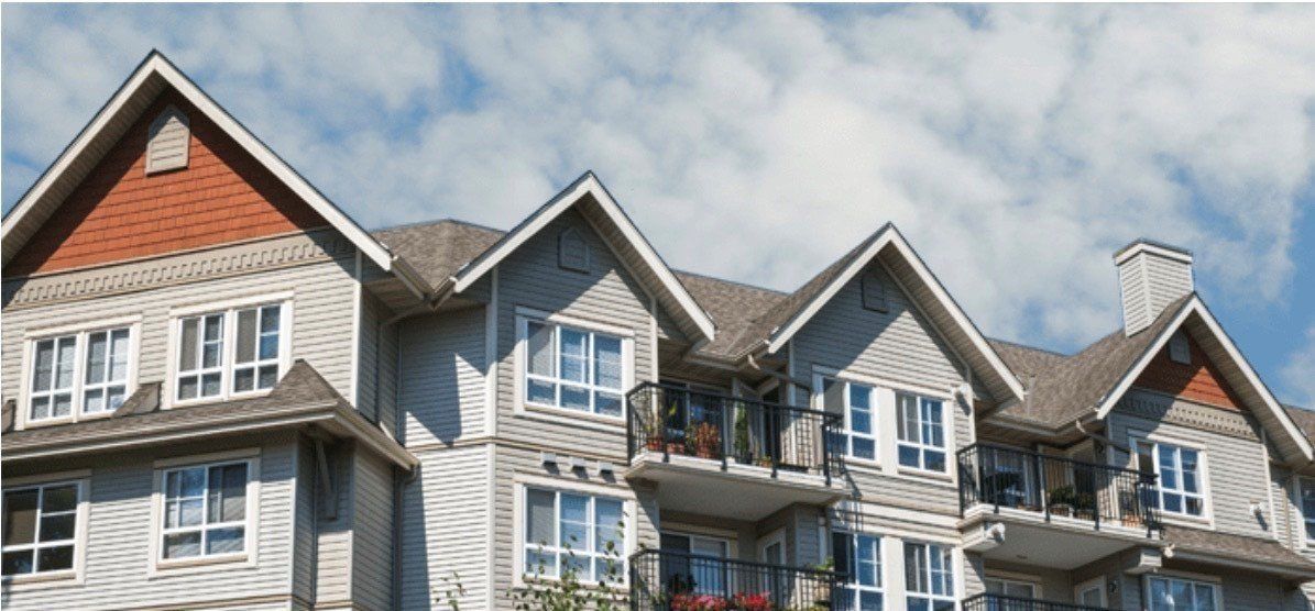 a large apartment building with a lot of windows and balconies
