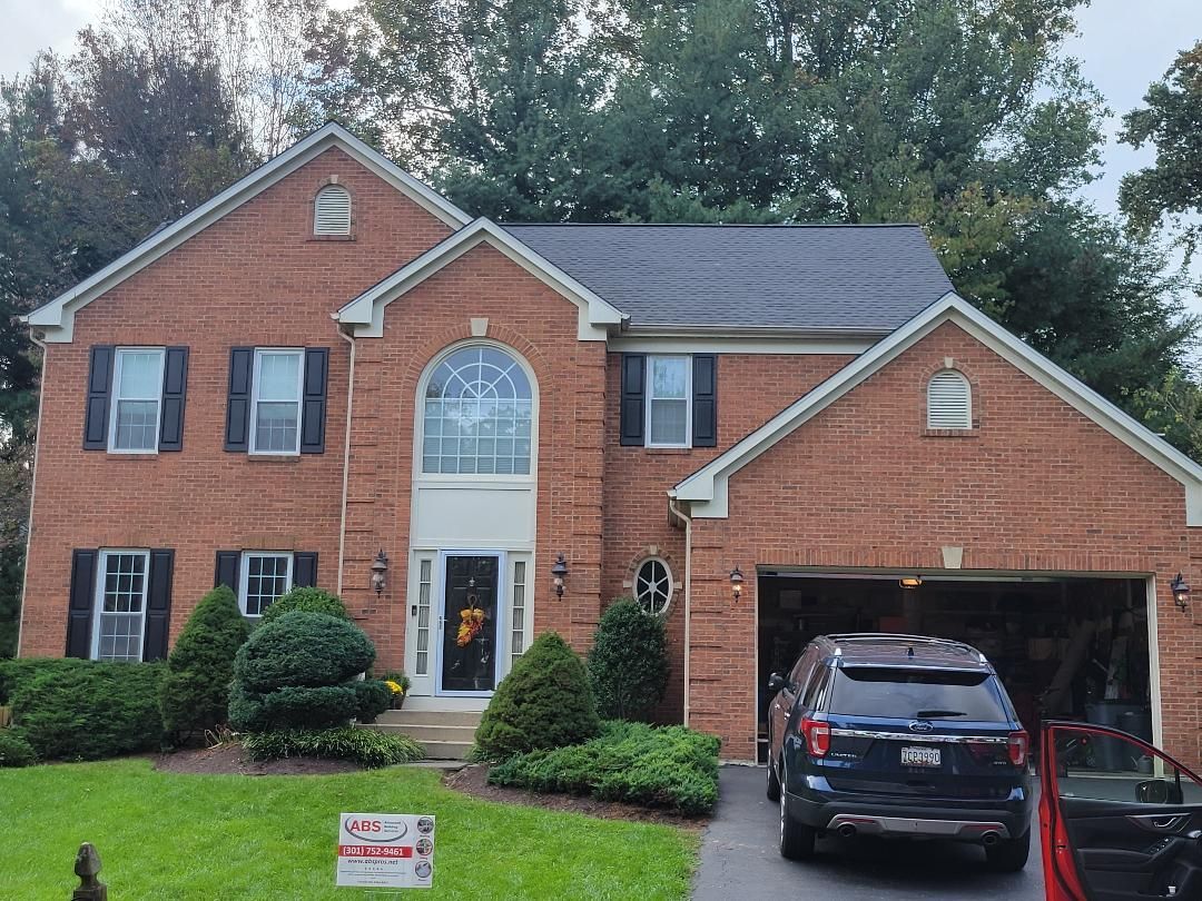 a large brick house with a car parked in front of it