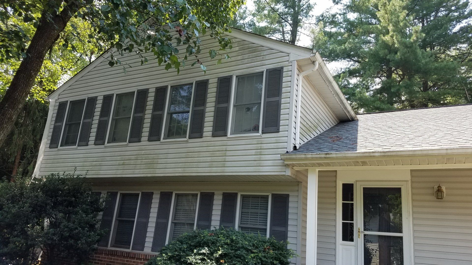 a house with a lot of windows and shutters on it