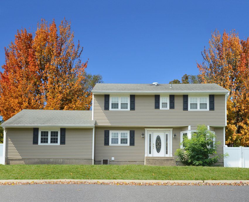 a house with a lot of windows and black shutters