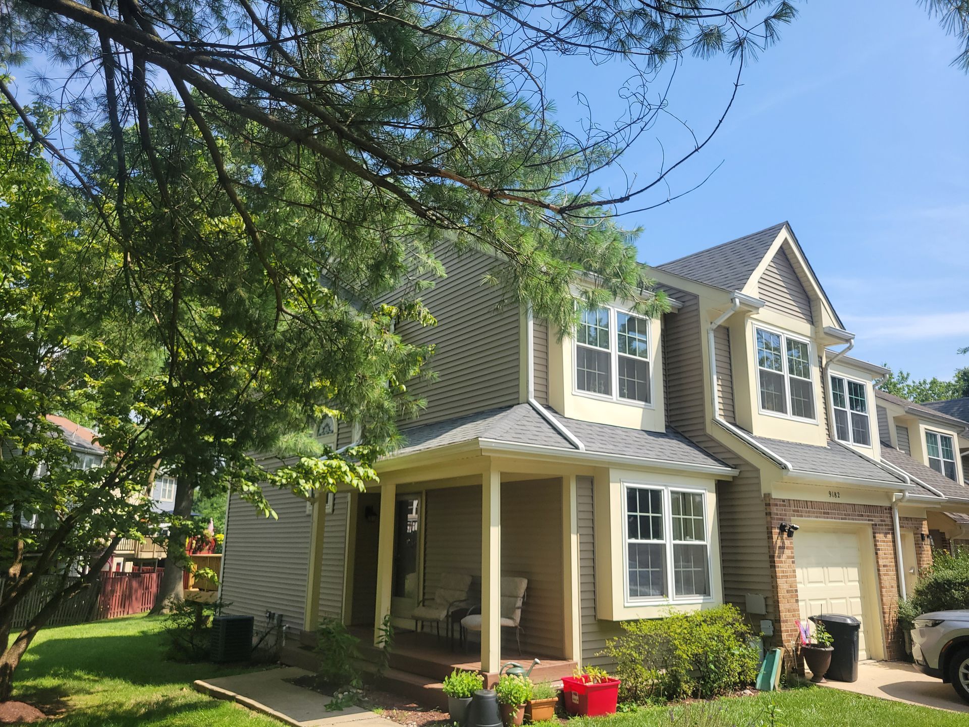 a house with a porch and a car parked in front of it