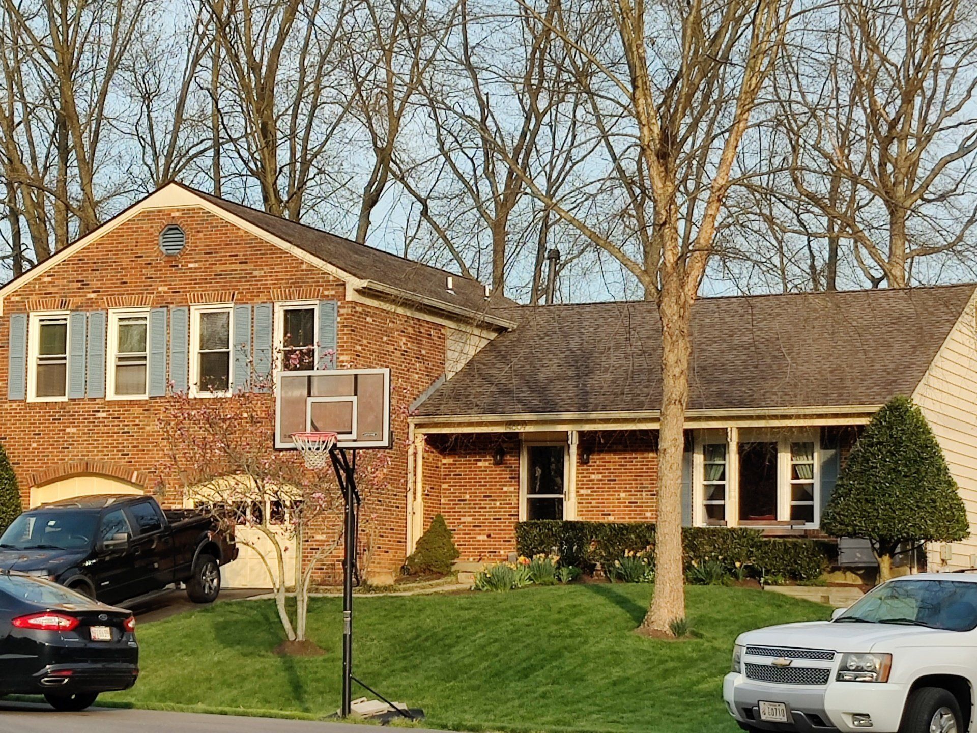a brick house with a basketball hoop in front of it