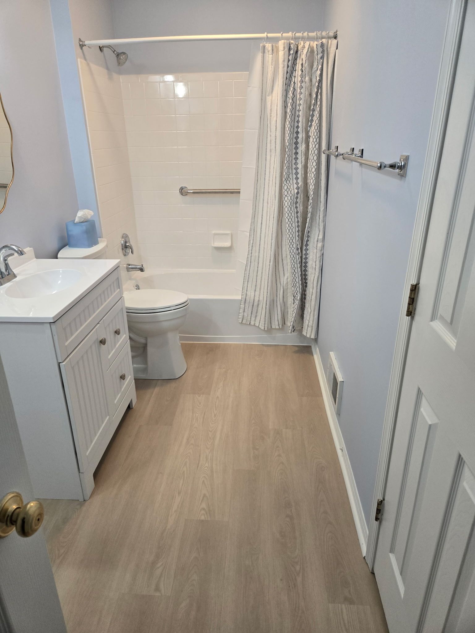 A bathroom with a toilet, sink, shower, and bathtub