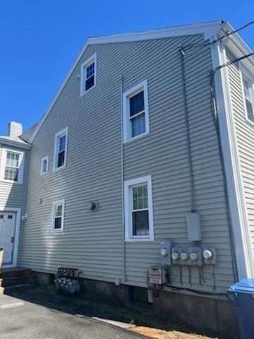 A large house with a lot of windows and a blue sky in the background.
