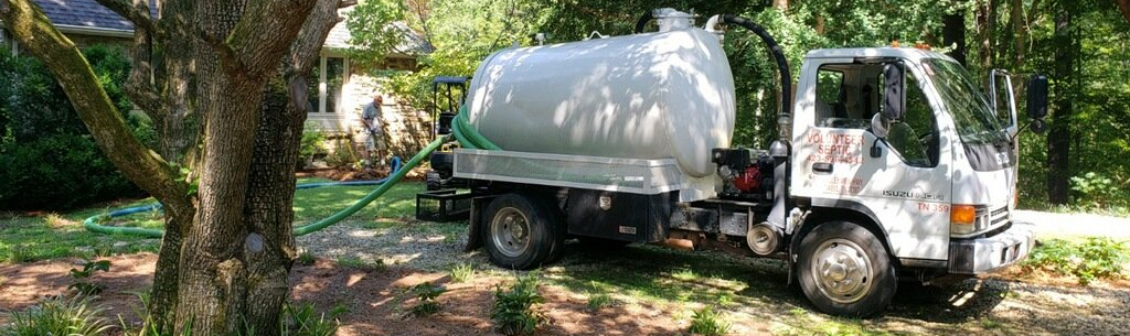 septic maintenance truck parked outside with septic pump
