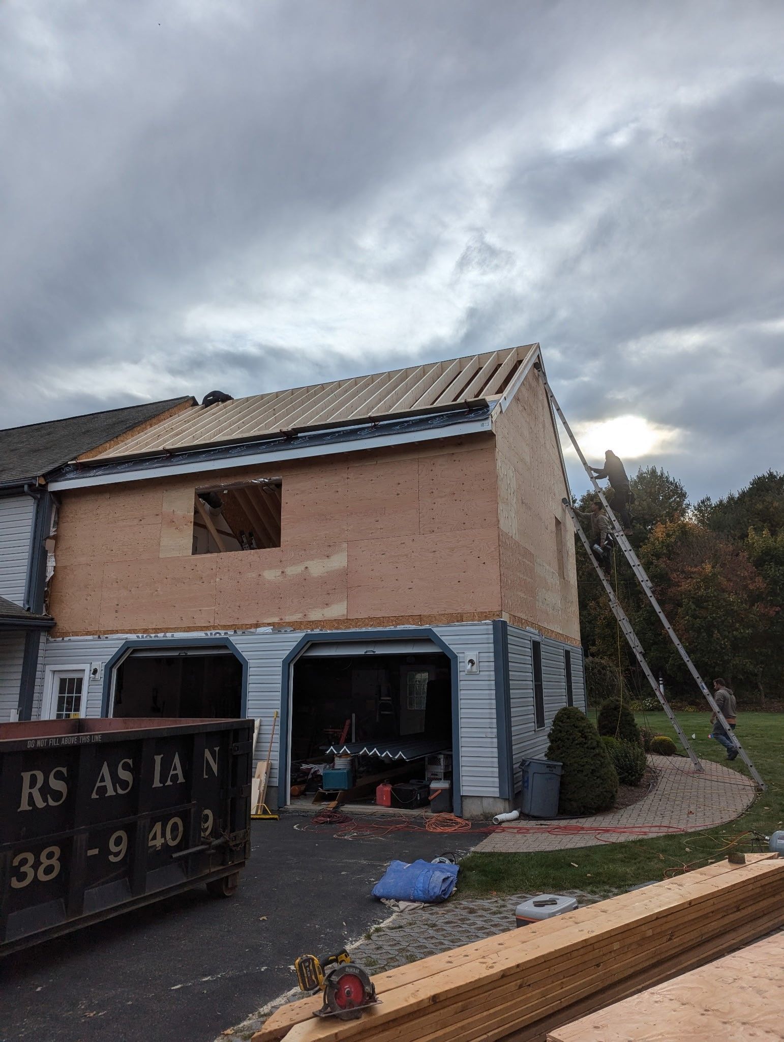 A house is being remodeled with a roof being installed.