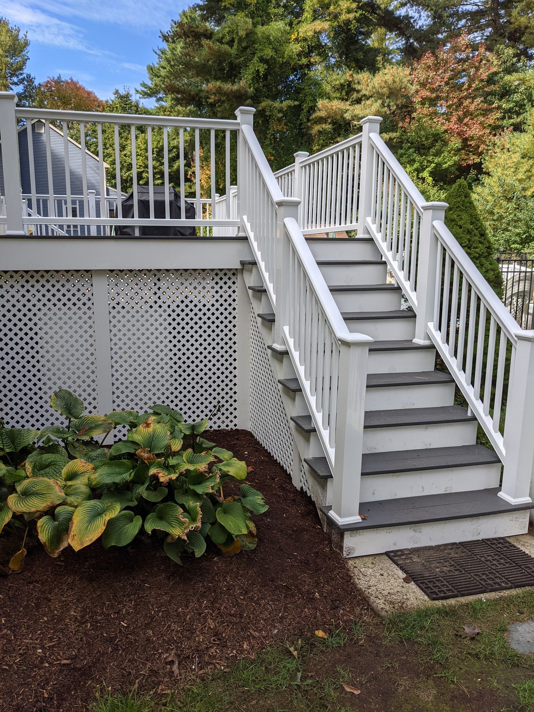 A white deck with stairs leading up to it