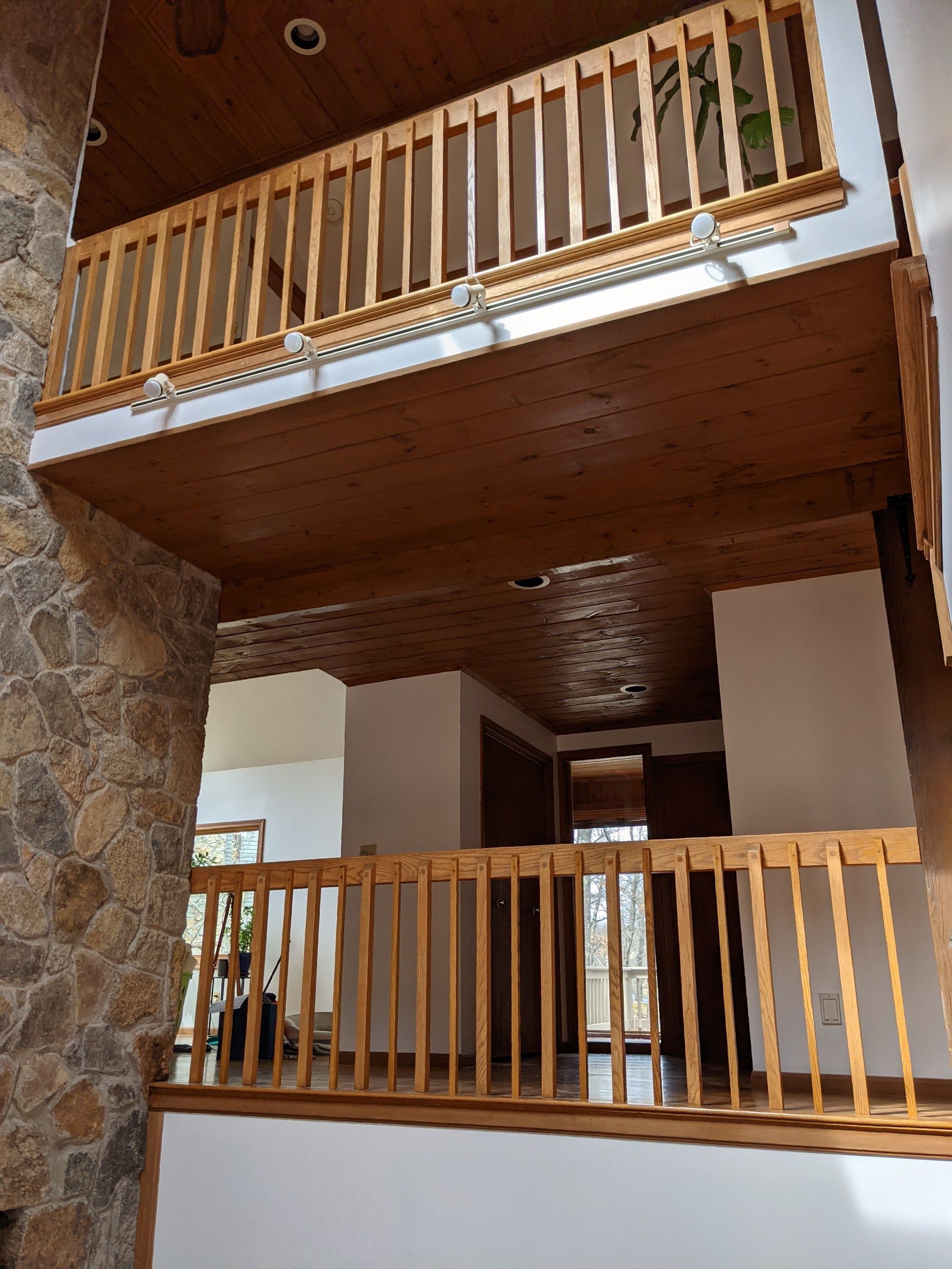 A balcony in a house with a wooden railing