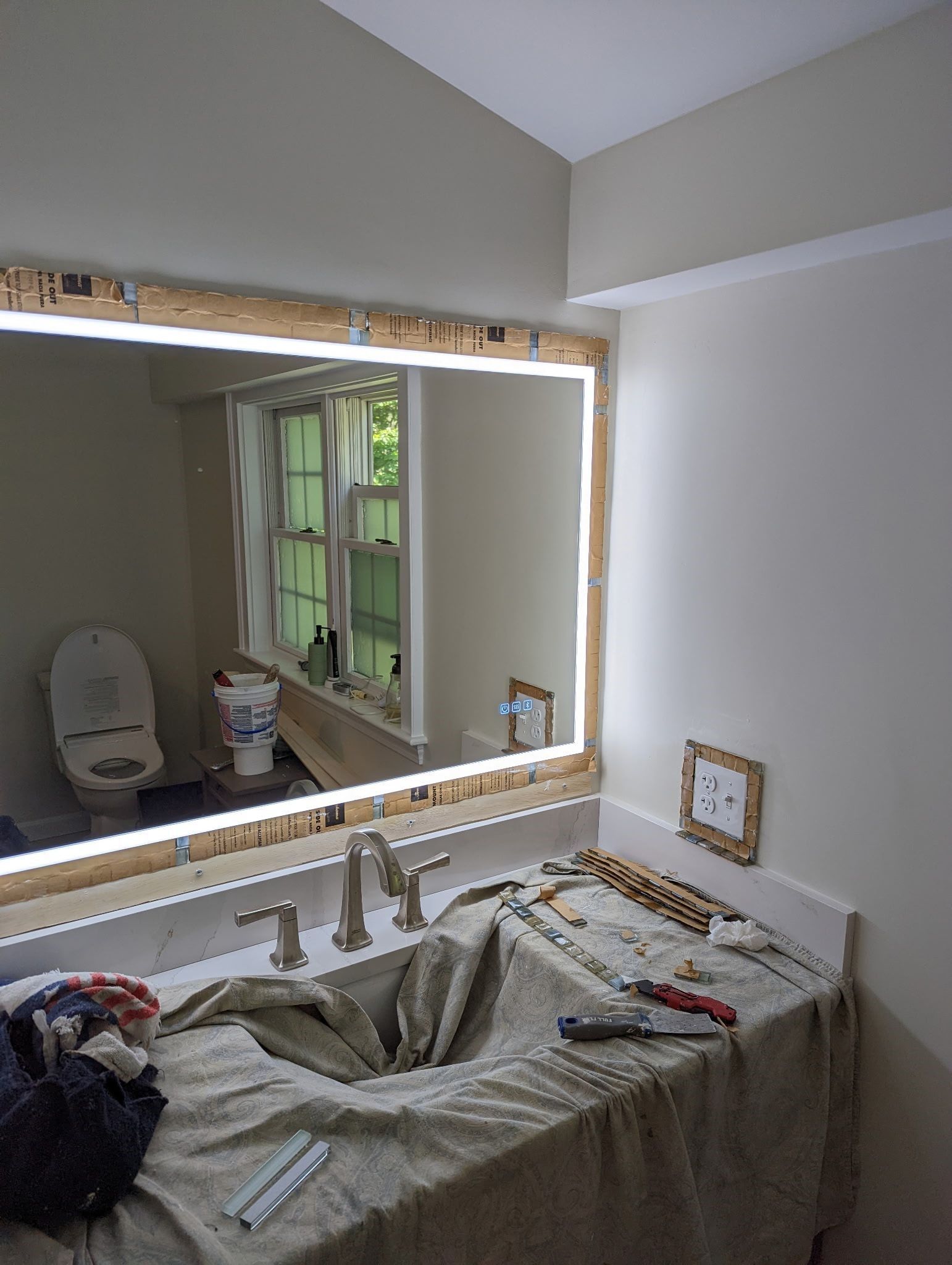 A bathroom with a sink , toilet , and mirror.