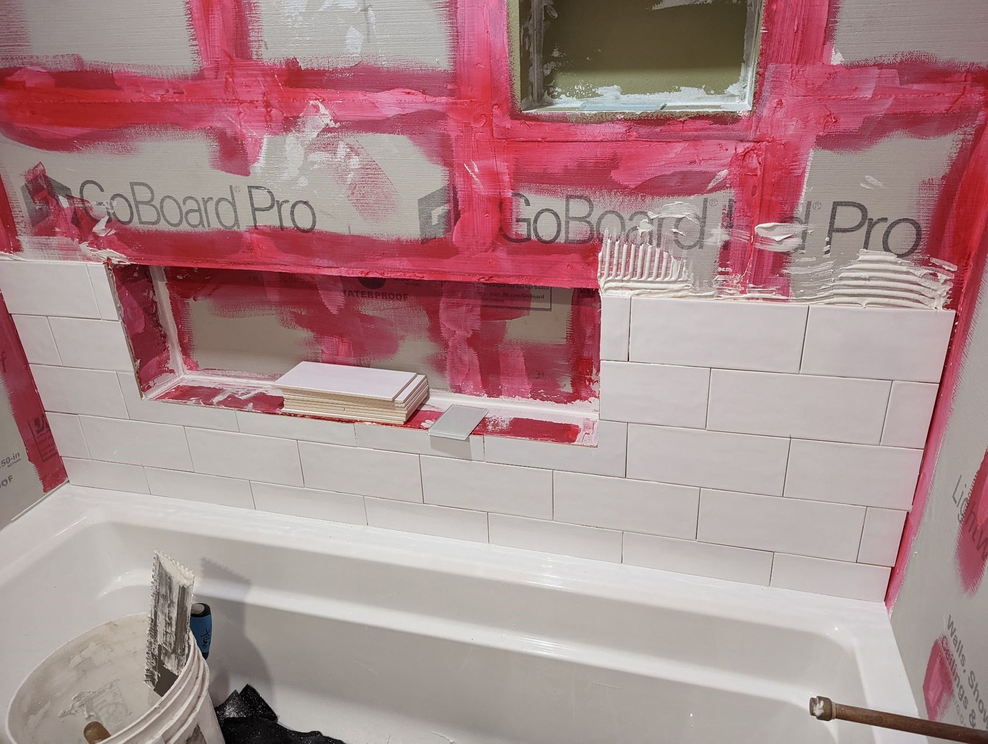 A bathtub is being remodeled in a bathroom.