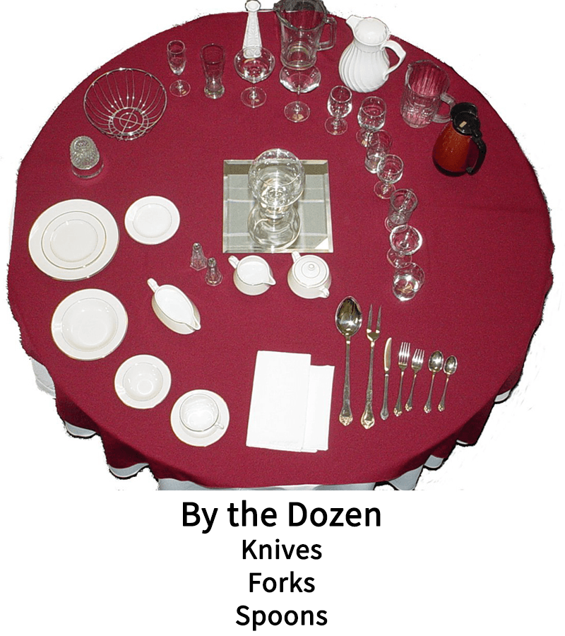 A table with knives forks and spoons on it