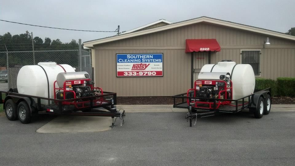 Two trailers are parked in front of a building that says southern glass supply