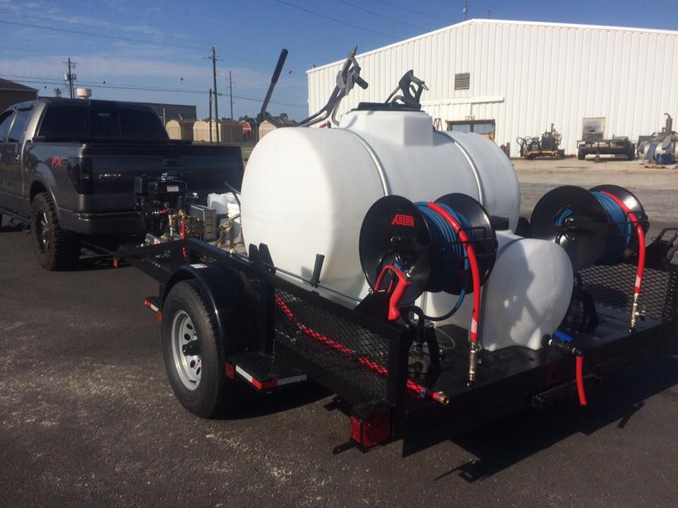 A truck is towing a trailer with a hose attached to it.