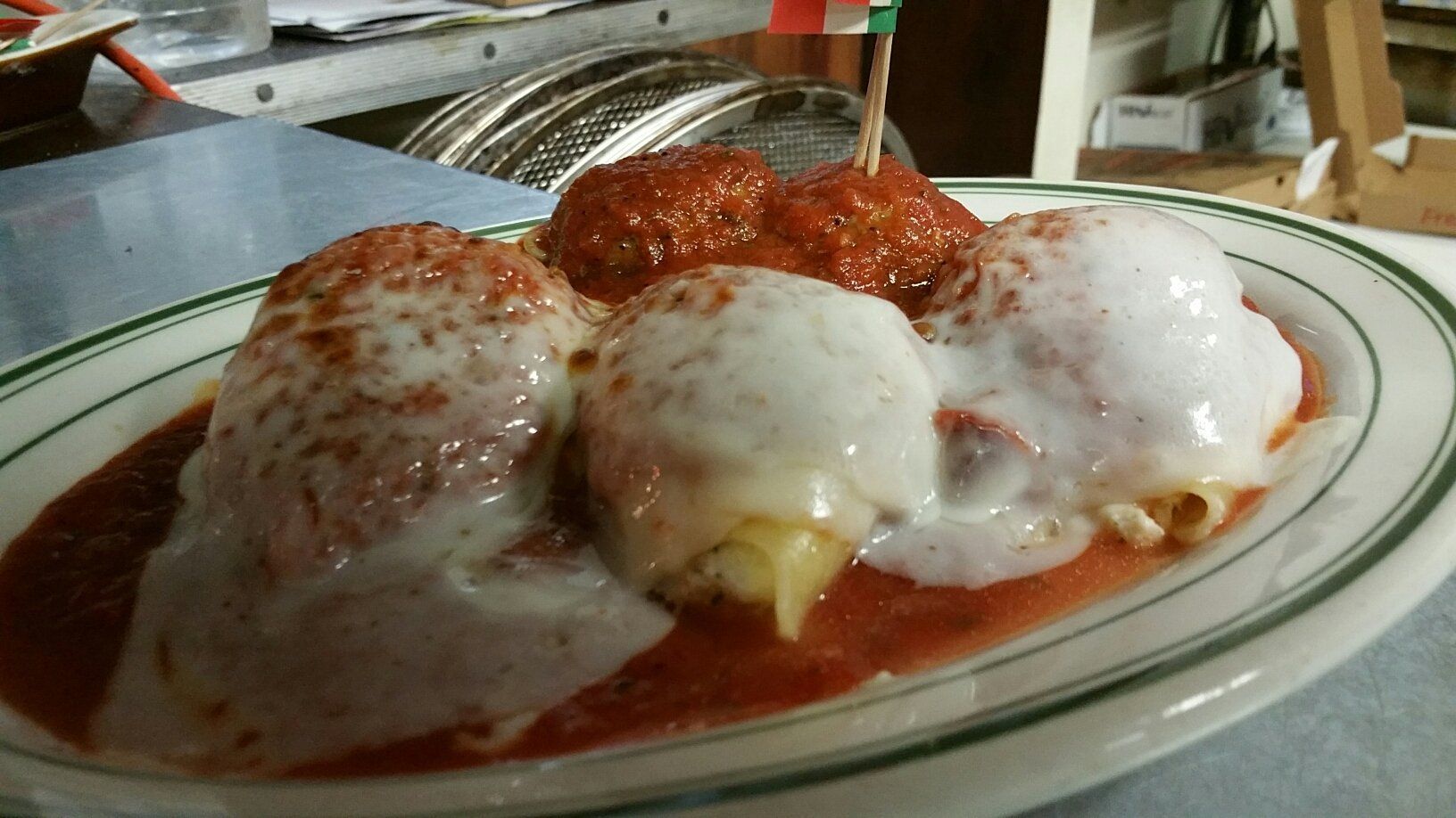 A white plate topped with meatballs and sauce on a table.