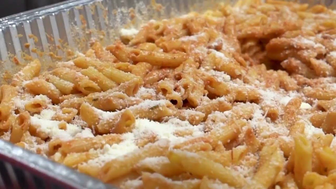 A close up of a casserole dish filled with pasta and cheese.