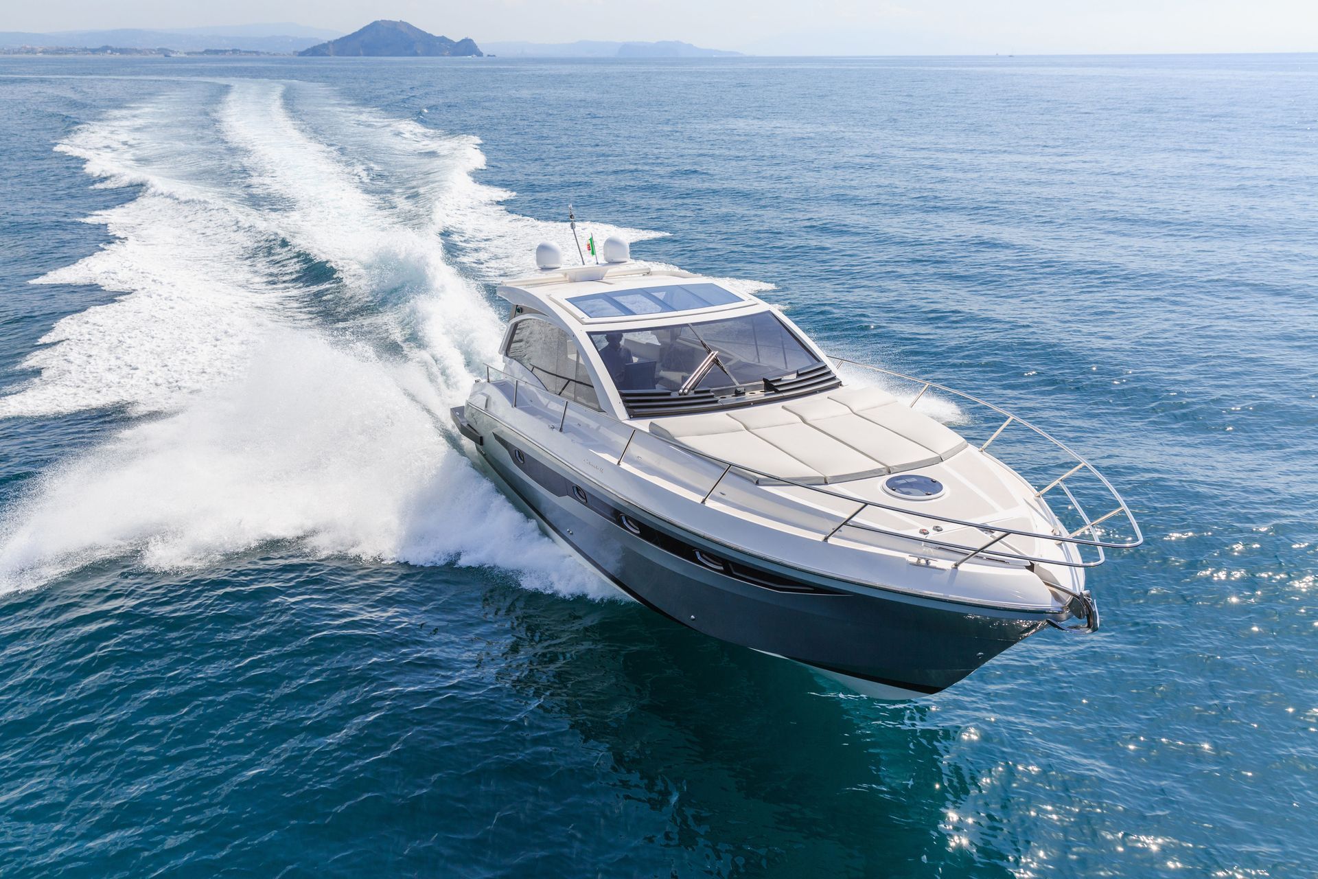 A boat is floating on top of a body of water.