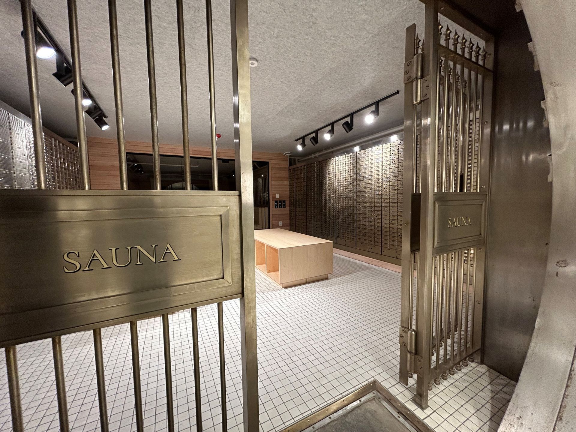Interior of a sauna with gold-toned metal gate. 