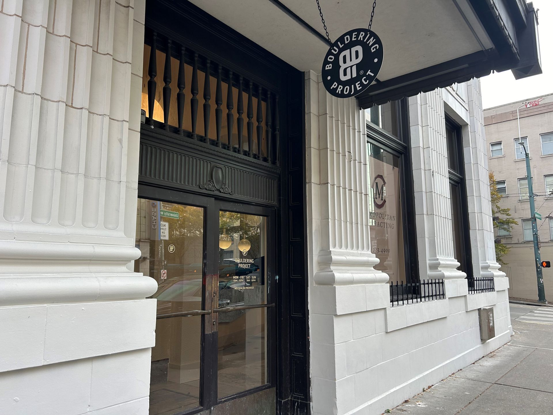 Building facade with black door and sign 
