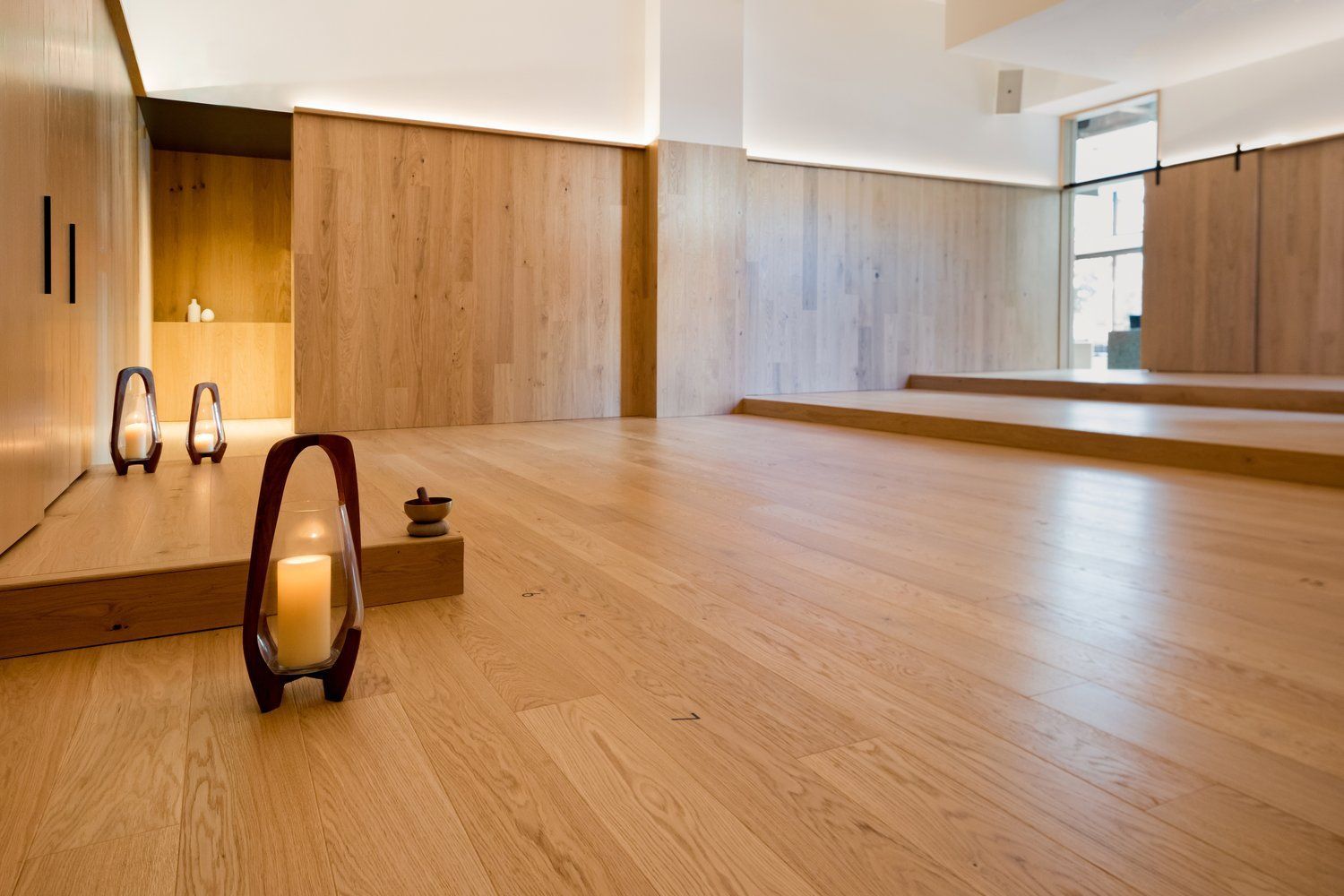 Wooden yoga studio with candle lanterns.