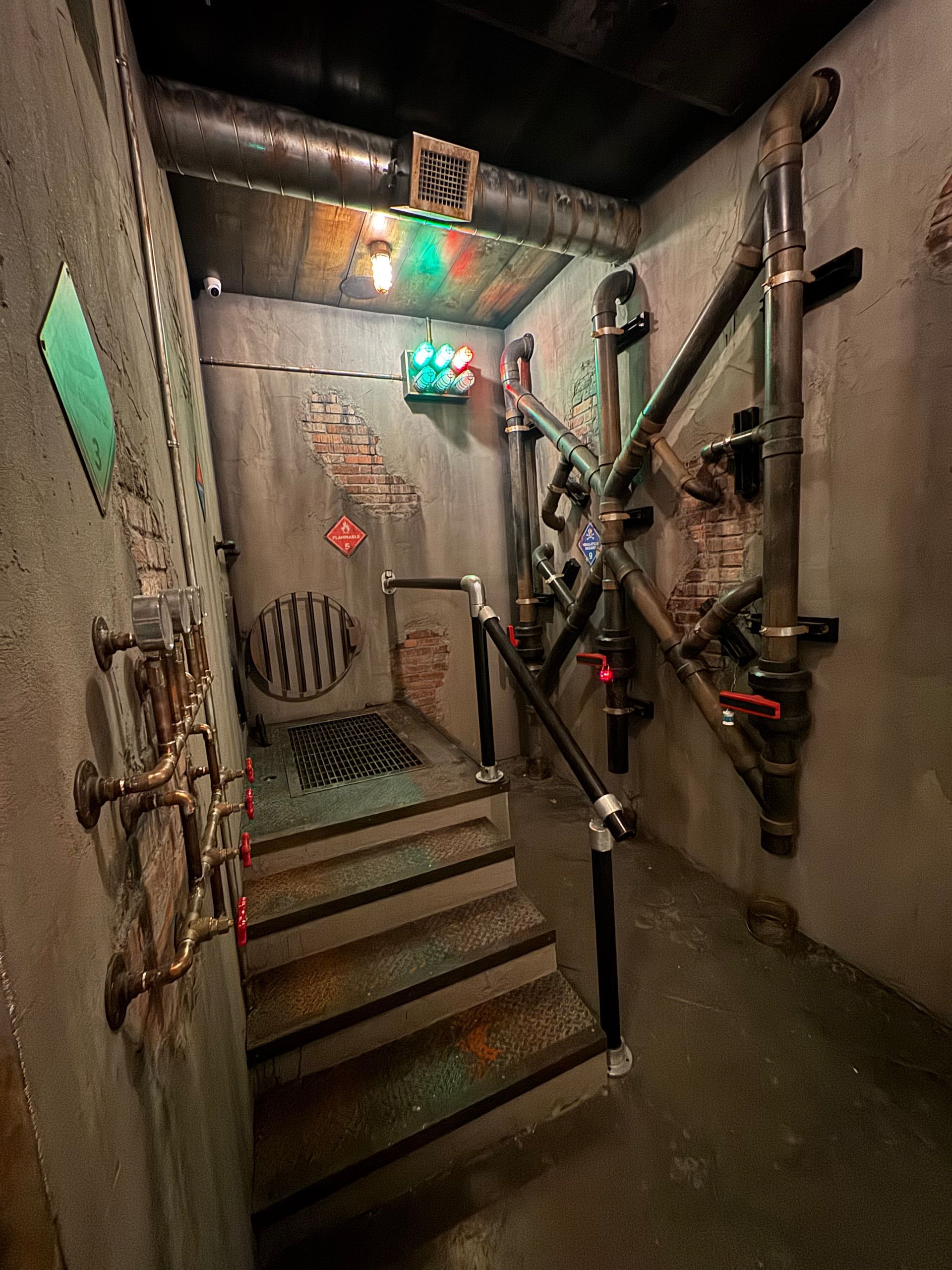 Industrial-style room with stairs, metal pipes, and brick accents.