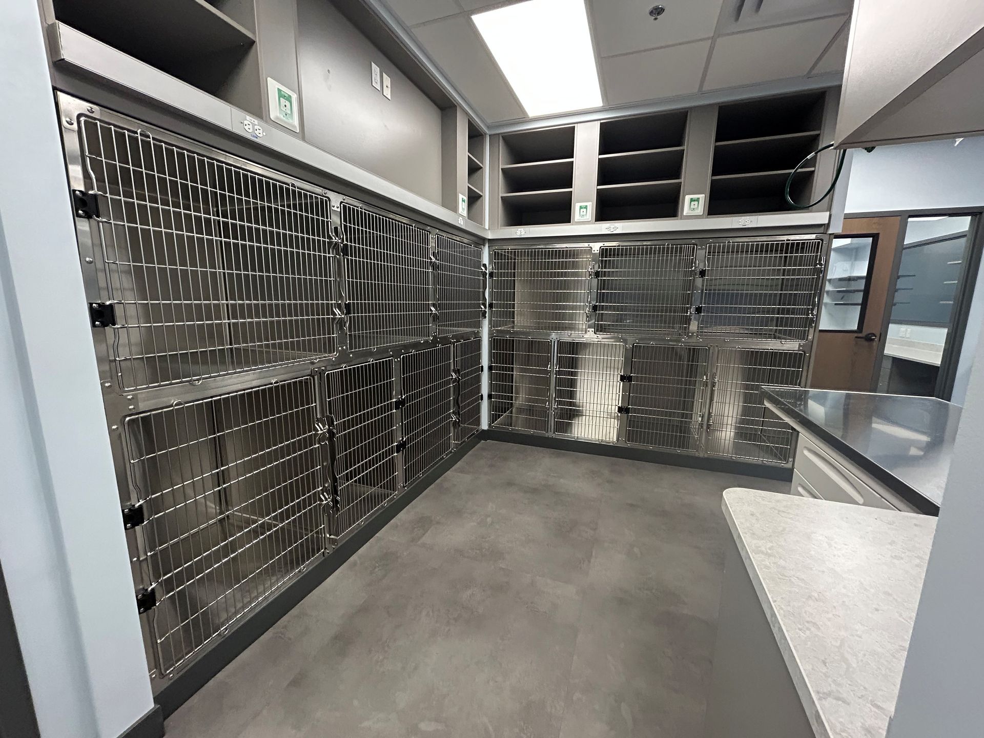Interior of a room with rows of metal postal boxes and shelves.