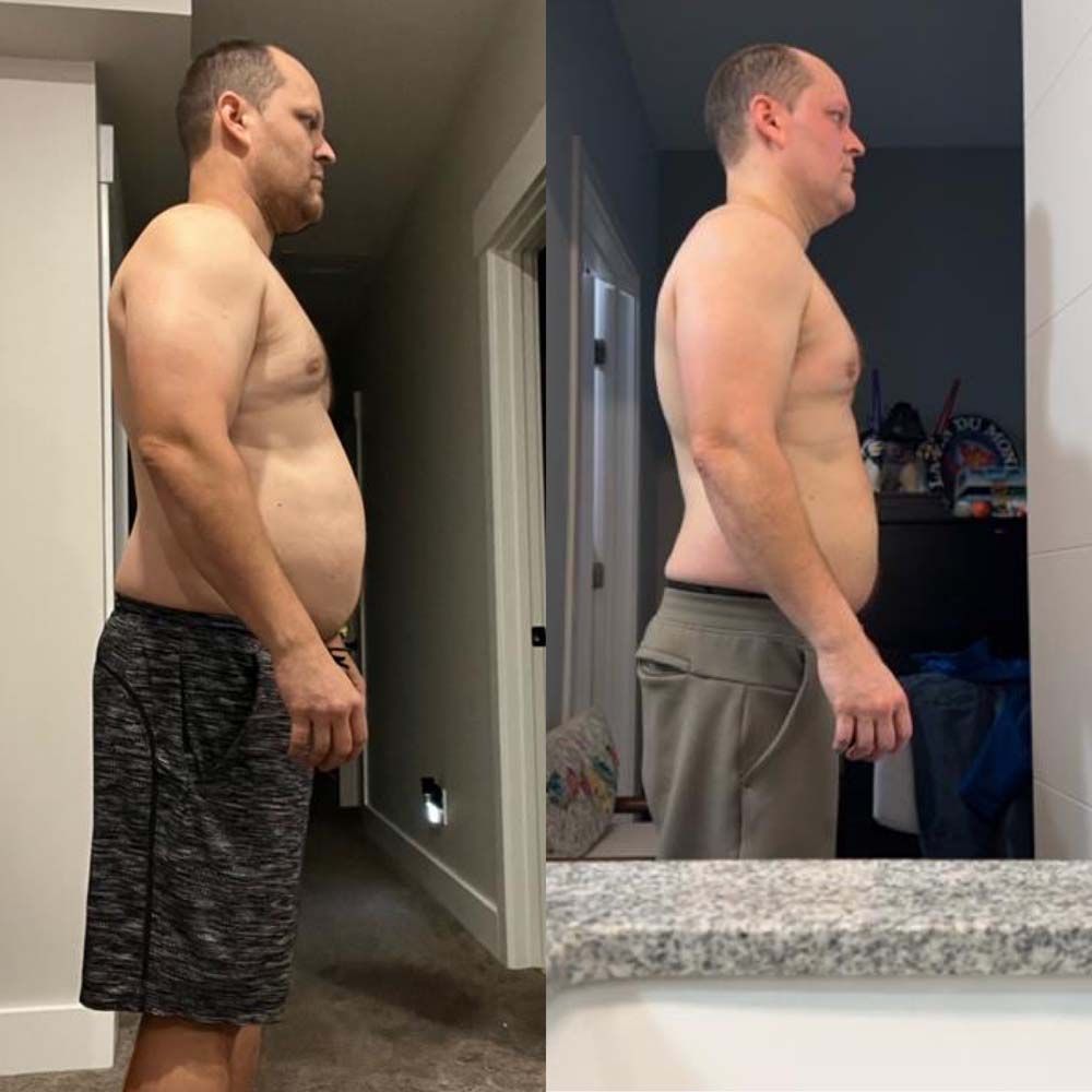 A man without a shirt is standing in front of a mirror