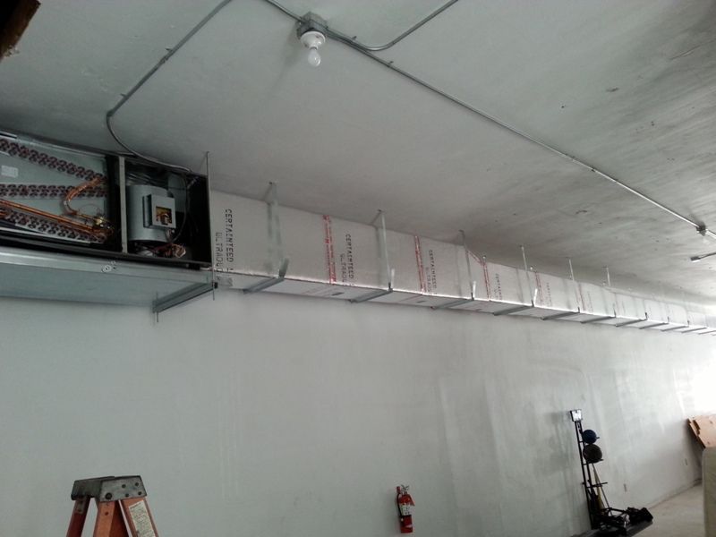 A ladder is hanging from the ceiling of a room.