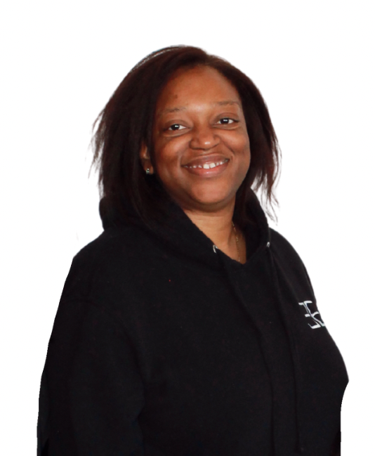 Naomi Pritchett with dark skin smiles wearing a black hooded sweatshirt.