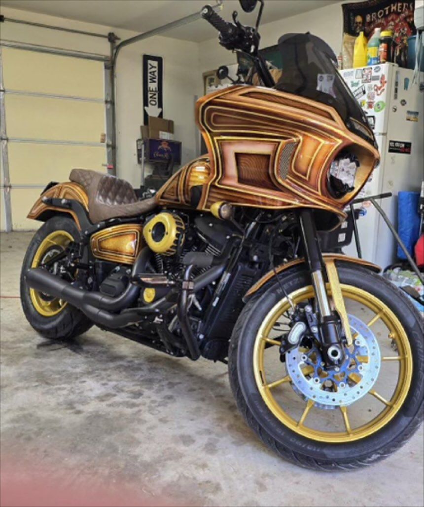 Custom gold and brown motorcycle in a garage.