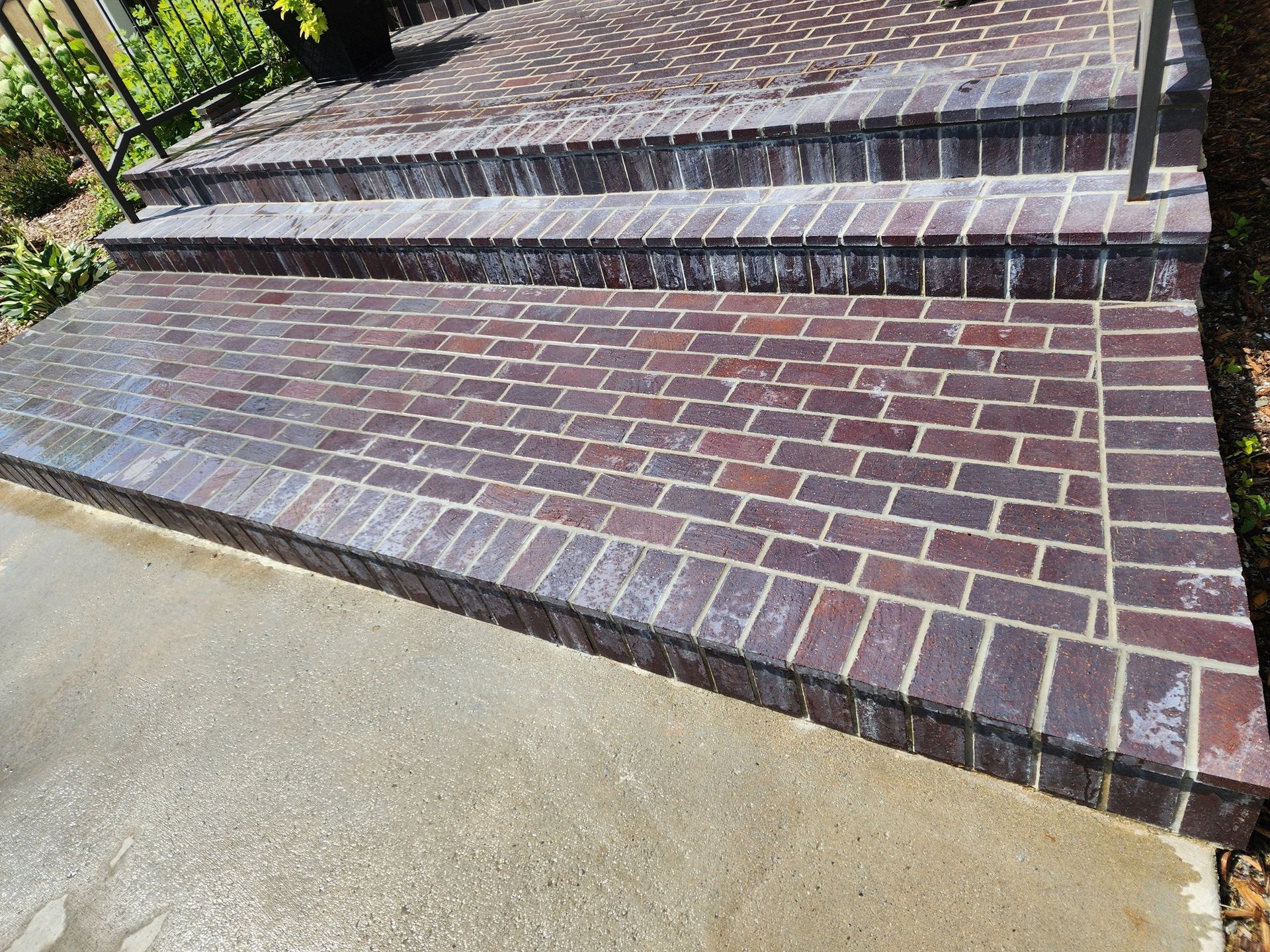 a set of brick steps leading up to a patio