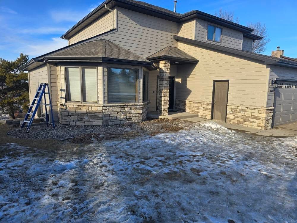 a house with a lawn covered in snow