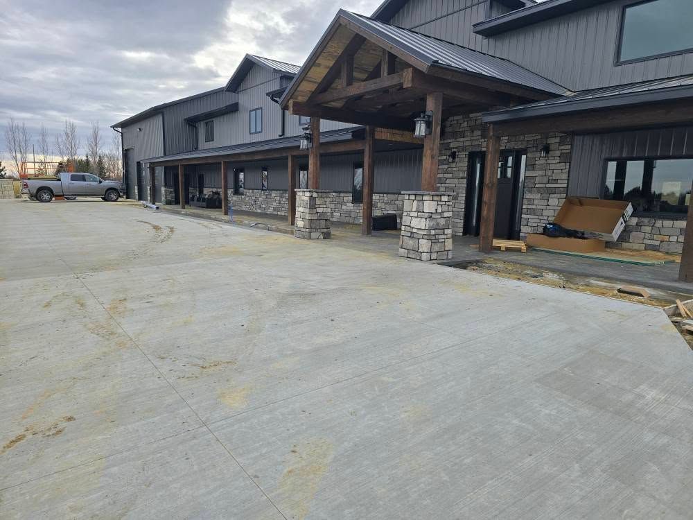 a huge house with a concrete driveway in front of it