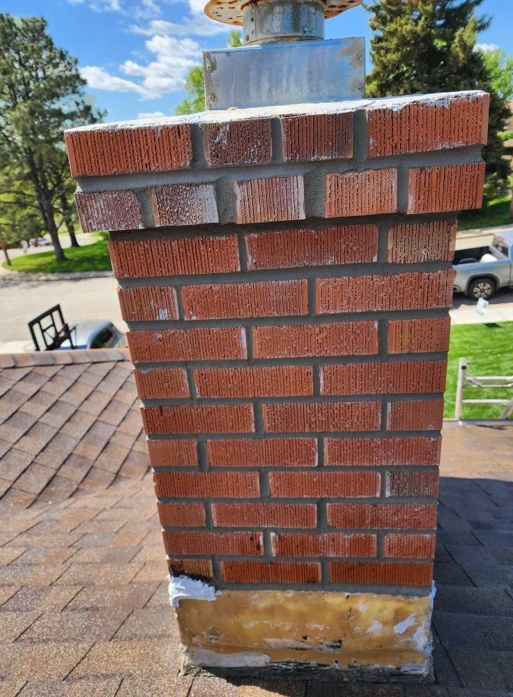 a brick chimney is sitting on top of a roof