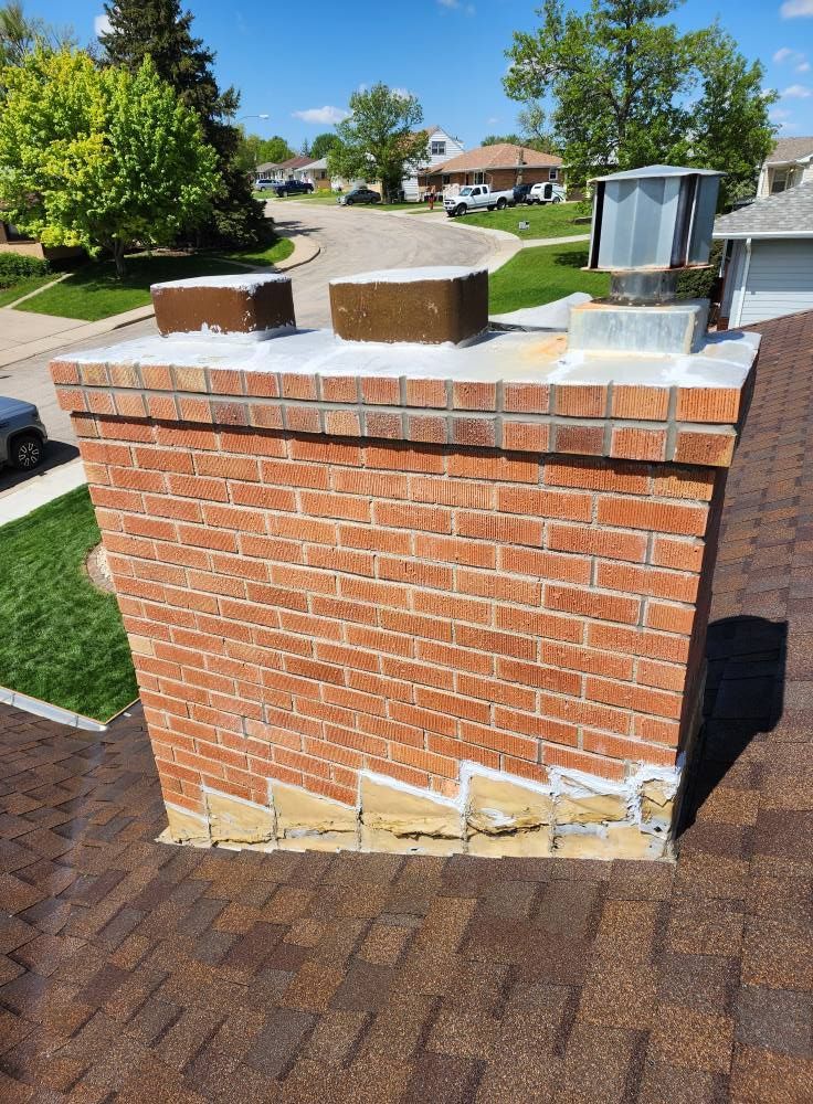 a brick chimney on top of a roof