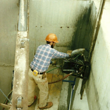 Worker cutting concrete