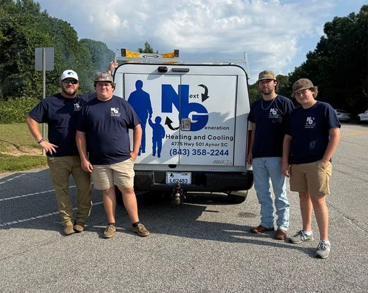 Four workers stand behind a white service van with a blue logo on a roadside.
