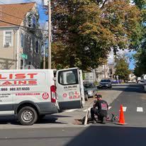 A white van is parked on the side of the road.